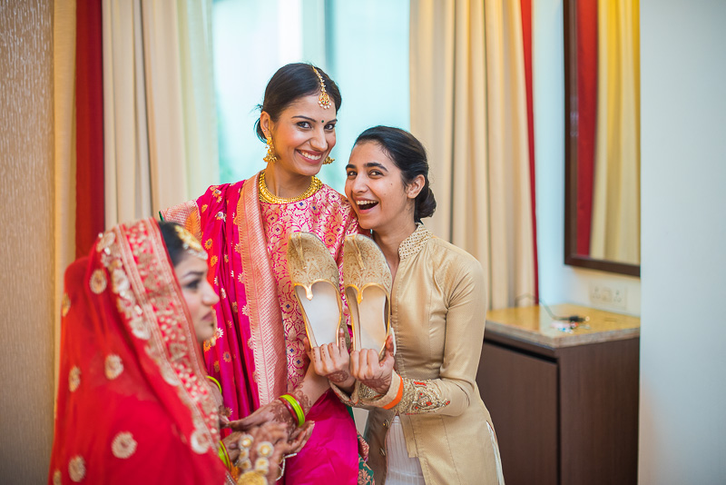 The ceremony of stealing the groom's shoes by bride's sisters