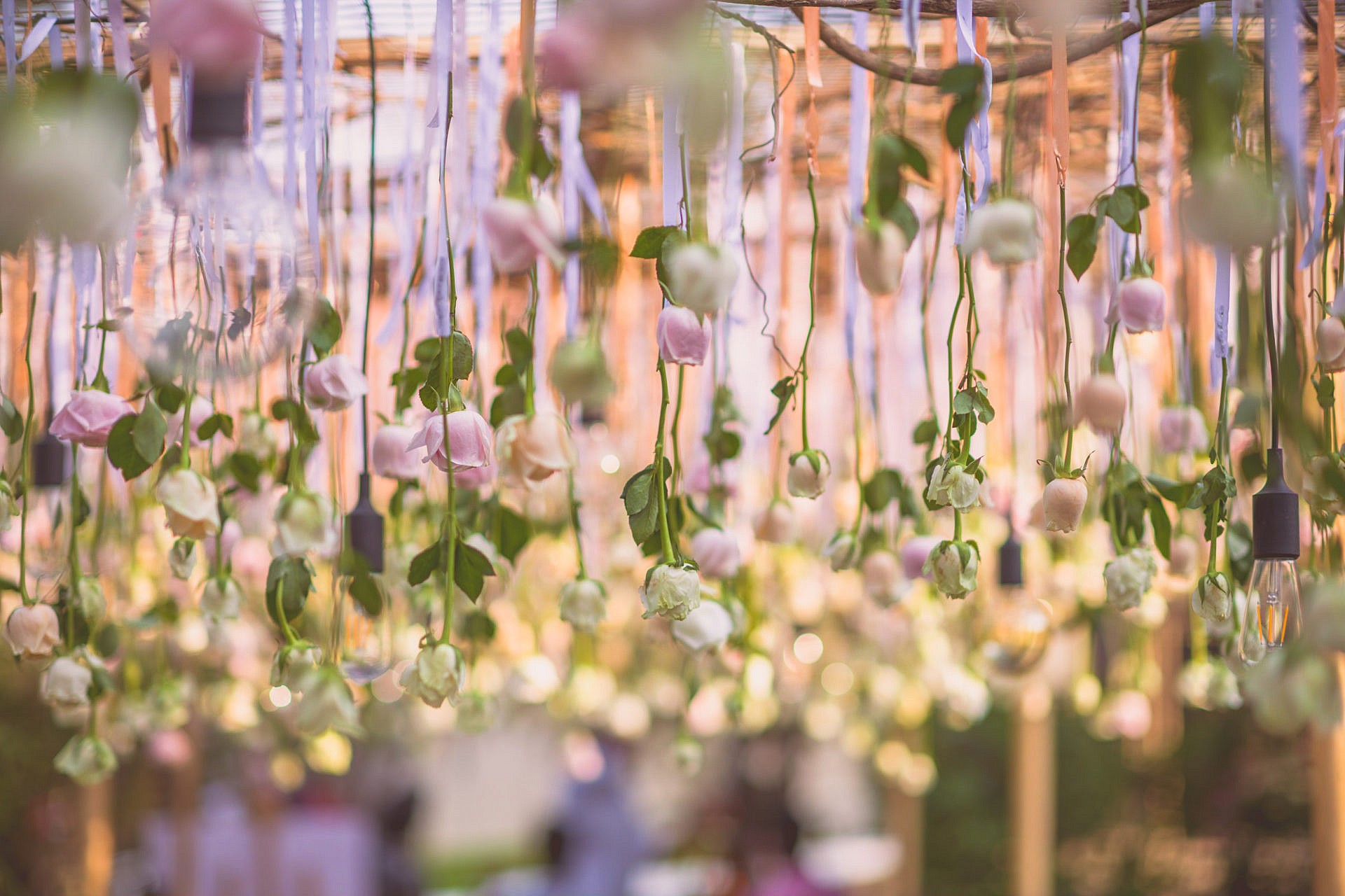 Flowers and edison bulbs make for an interesting wedding decor choice