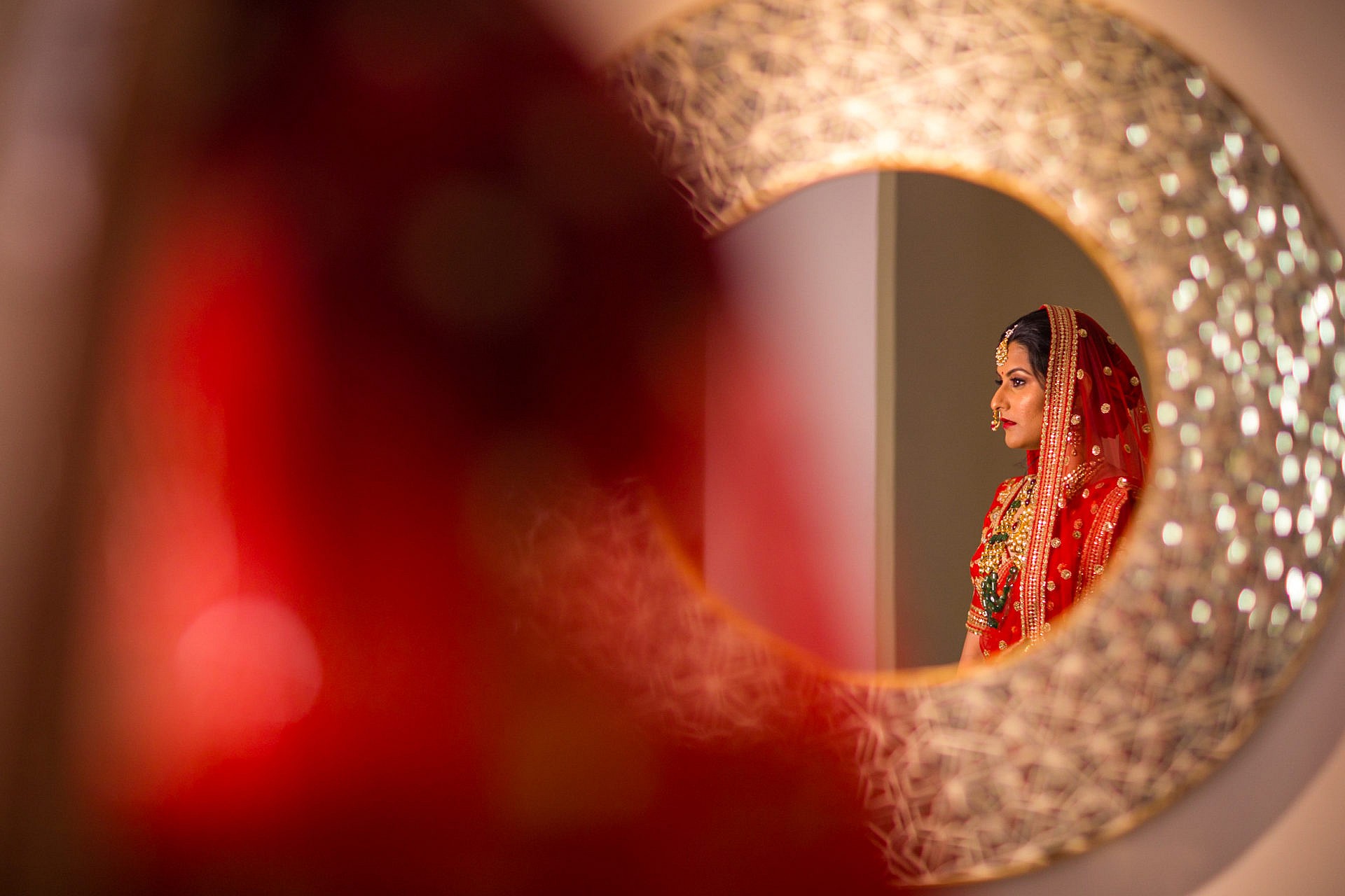 Bride's reflection in the mirror as she waits on her wedding day