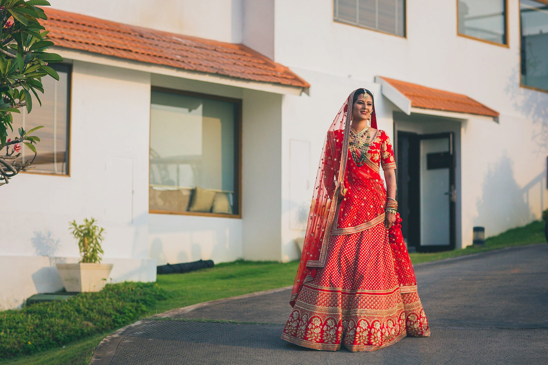 portrait of an indian bride in red lehenga