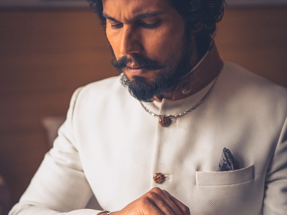 Randeep Hooda adjusting his bracelet in men's formal wear