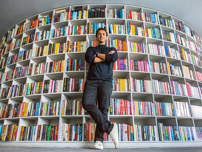 Durjoy Datta against a wall of books