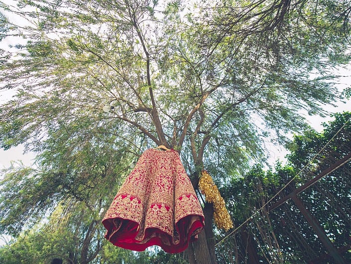bridal lehenga hanging from a tree