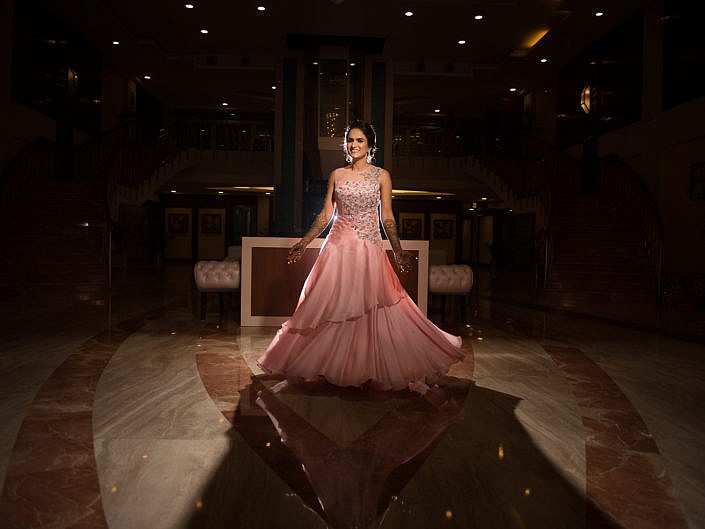 bride twirling in her pink evening gown for bridal portrait