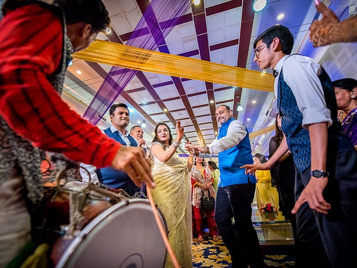 couple dancing to the drums at indian wedding party
