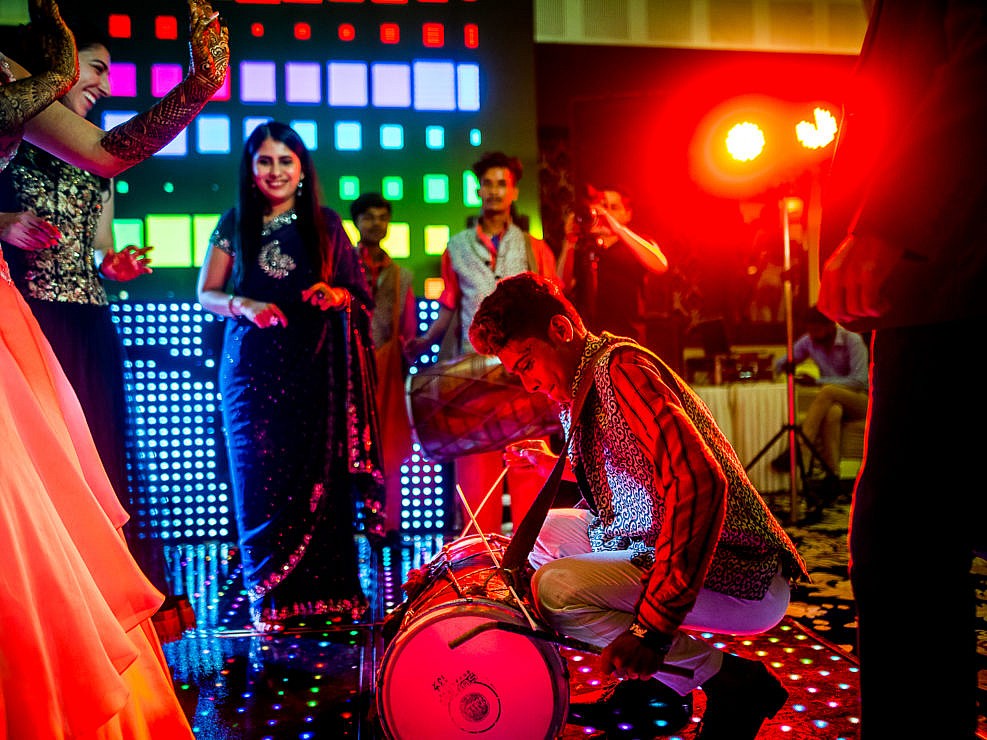 high contrast image of a drum player at indian wedding