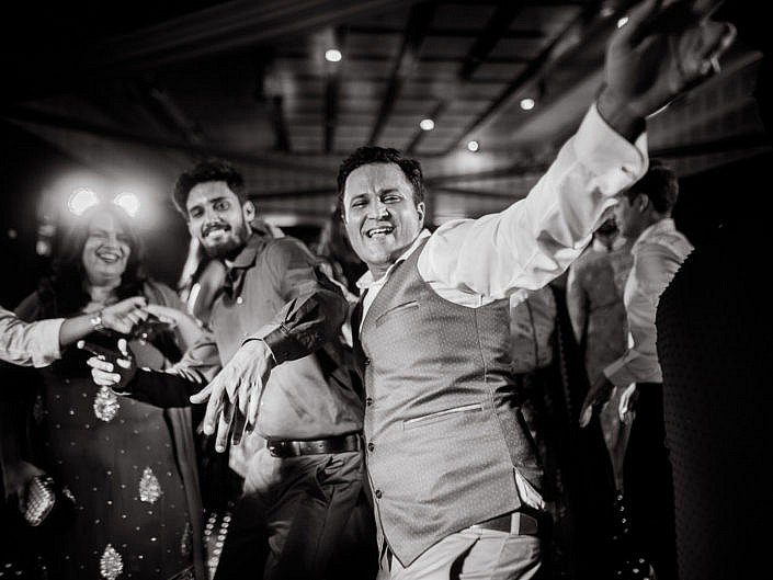 black and white dancing photo of a man with his friends