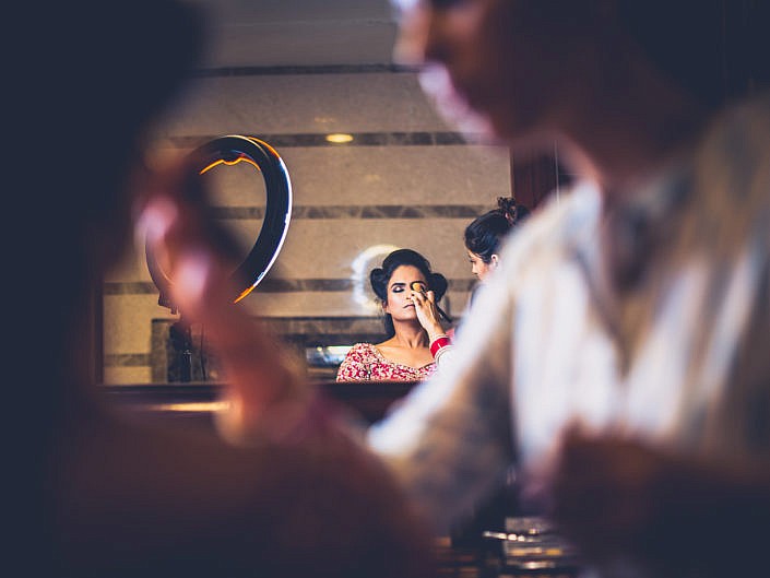 makeup being applied on the bride's eyes for indian wedding