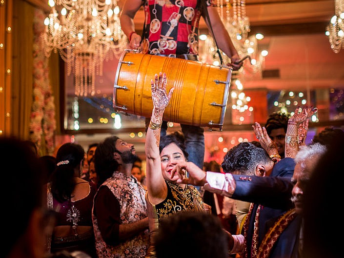 man playing big drums as a woman dances