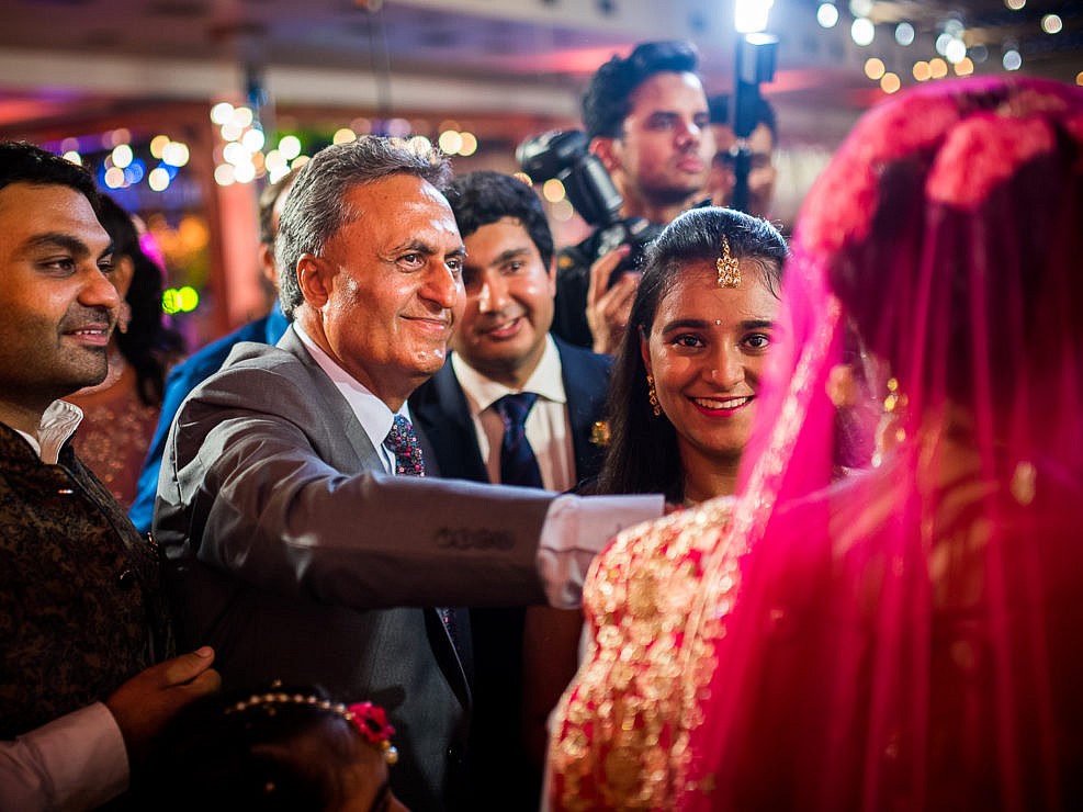 bride's father with guests around him
