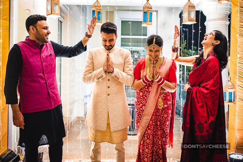 candid portrait of indian couple with family on wedding